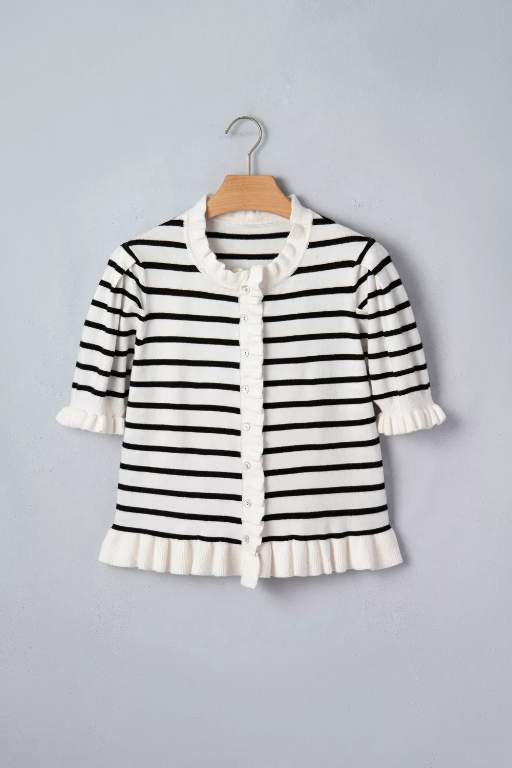 Black and white striped maternity cardigan with ruffle trim and buttons.