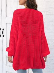 Red balloon sleeve cardigan with pearl buttons and open knit detail.