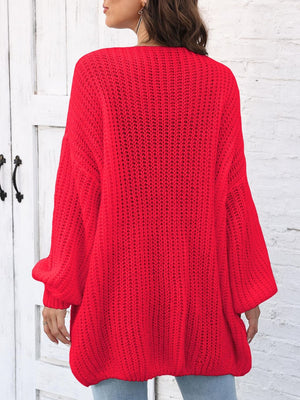 Red balloon sleeve cardigan with pearl buttons and open knit detail.