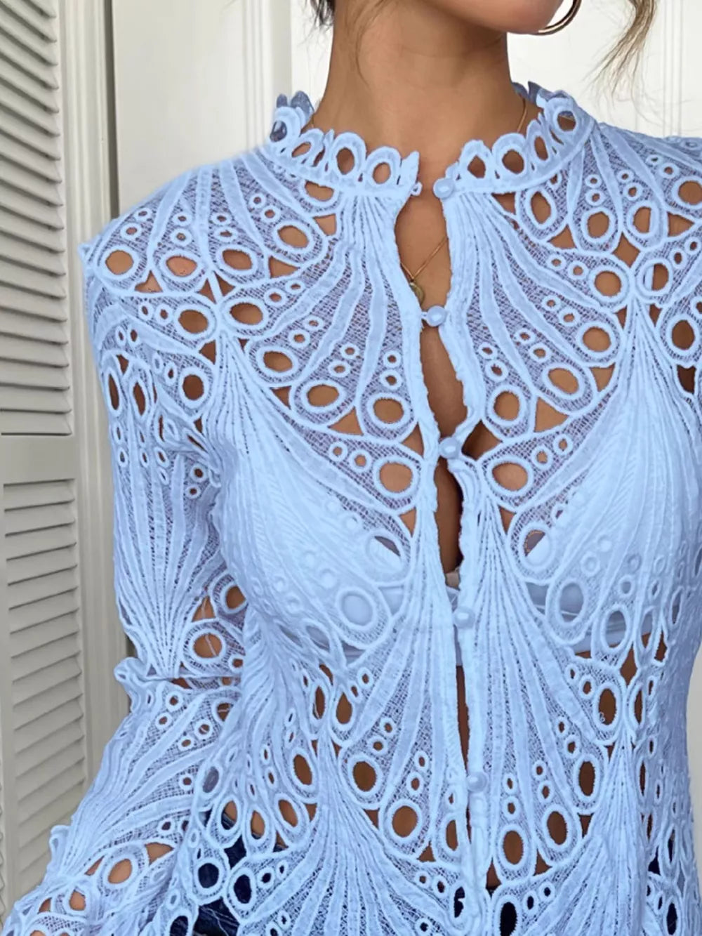 Blue lace button-up blouse with scalloped collar and intricate cutout pattern.