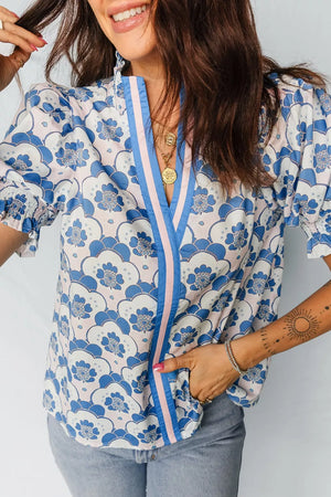 Playful floral print polyester blouse with puff sleeves, frill collar, and striped neckline detail.