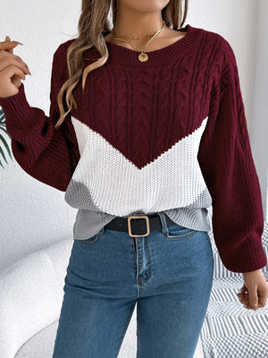 Chevron cable knit sweater in burgundy, white, and grey with a round neckline.