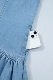 Light wash denim dress with ruffled hem and side pocket holding a phone.