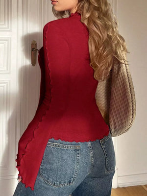 Red lettuce edge flare sleeve t-shirt with mock neck, styled with jeans.