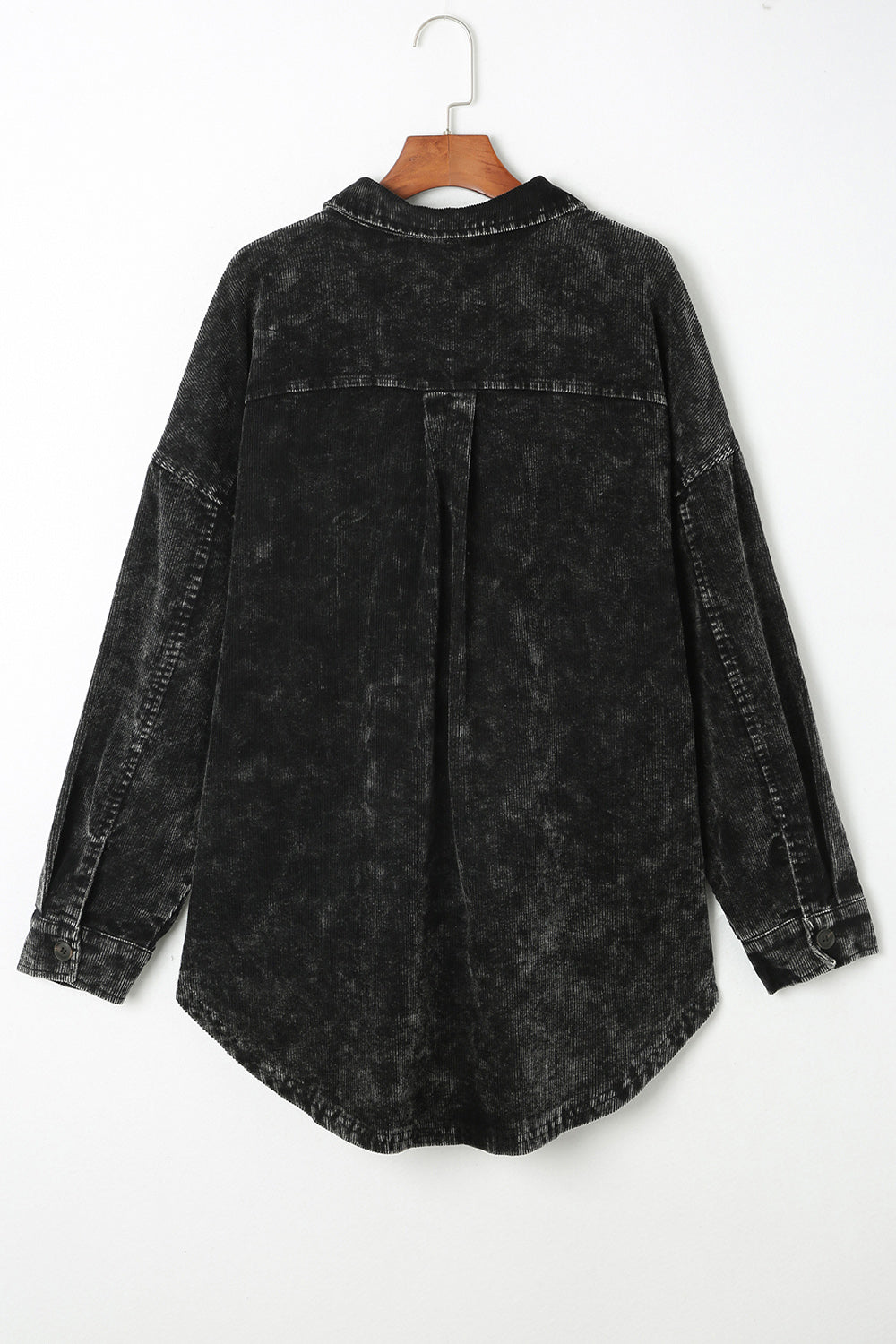 Black textured corduroy overshirt with faded wash and button details.