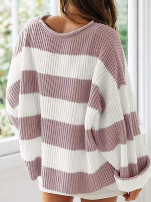 Striped oversized knit sweater in dusty pink and white with a crew neck and cuffed sleeves.