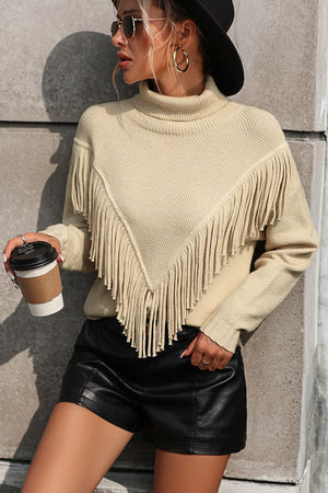 Beige turtleneck sweater with chevron fringe detail and textured knit.