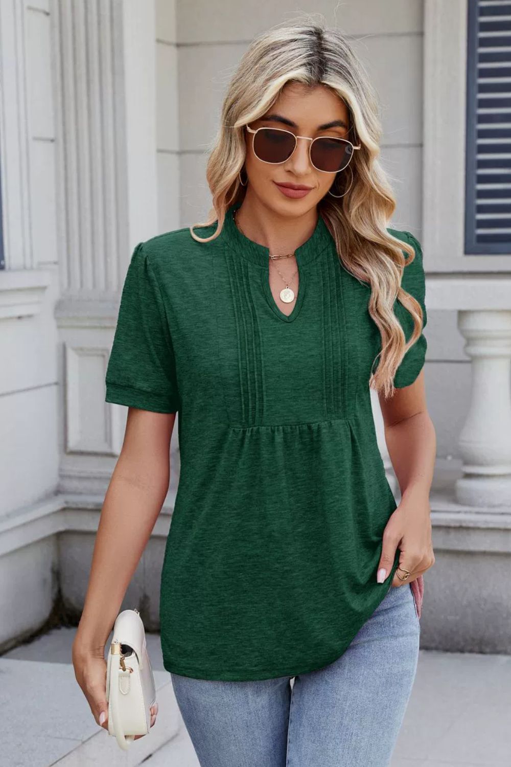 Dark green short sleeve henley tee with pleated yoke detail and keyhole neckline.