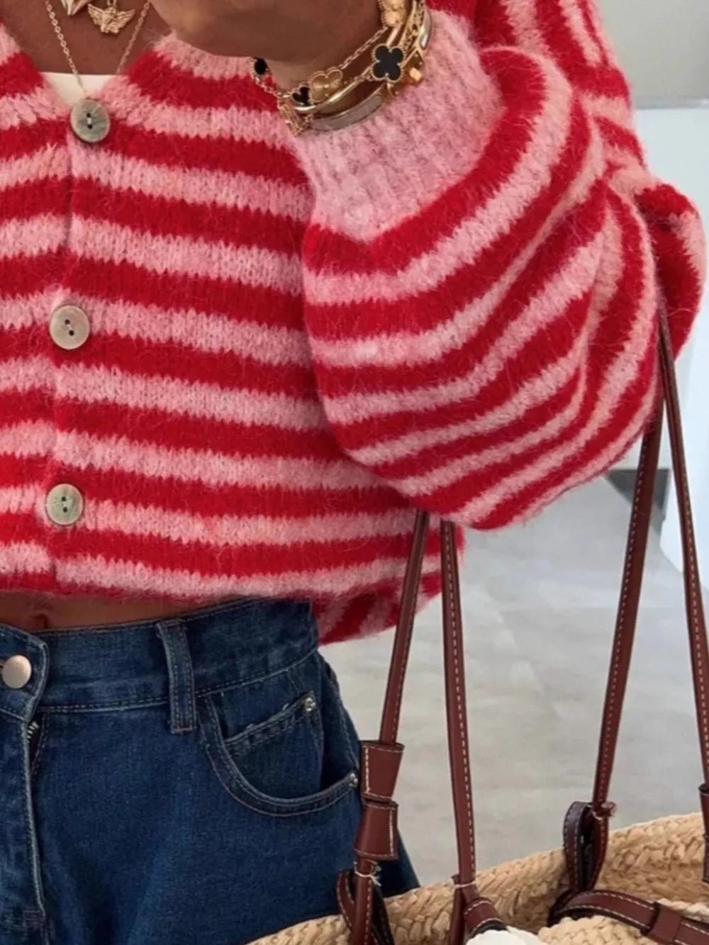 Charming cropped red and pink striped knit cardigan with balloon sleeves and button front.