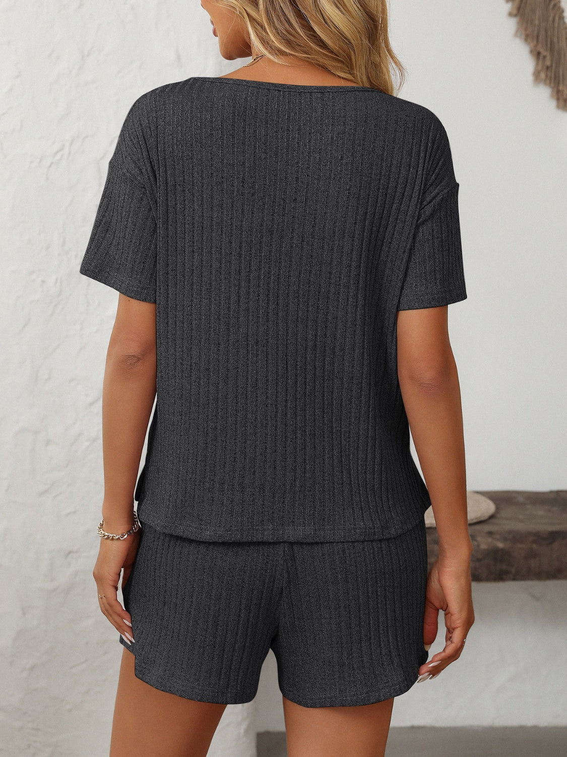 Black ribbed V-neck loungewear set with short sleeves and shorts.
