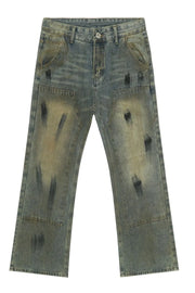 Distressed medium wash denim carpenter jeans with black brushstroke details.