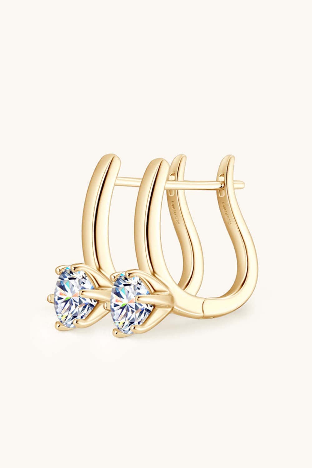 Gold solitaire huggie hoop earrings with clear cubic zirconia stones.