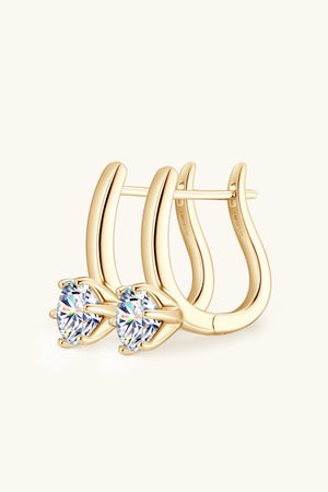 Gold solitaire huggie hoop earrings with clear cubic zirconia stones.