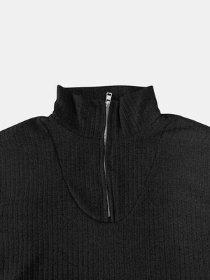 Black ribbed knit quarter-zip pullover sweater with a mock neck and silver zipper.