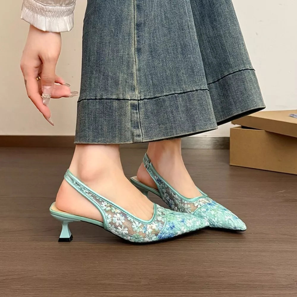 Elegant lace slingback kitten heels in green with floral pattern and pointed toe.