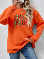 Orange graphic sweatshirt with Feliz Navidad text and Christmas lights.
