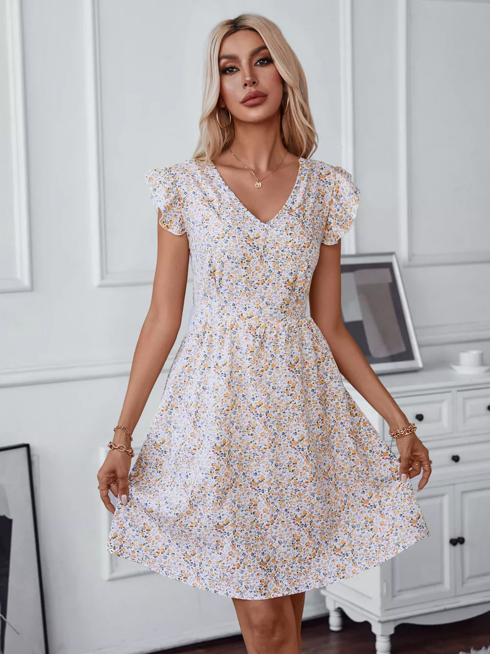 White ditsy floral mini dress with v-neck and ruffled short sleeves