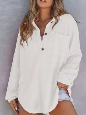 White waffle-knit henley tee with pocket and button detail.