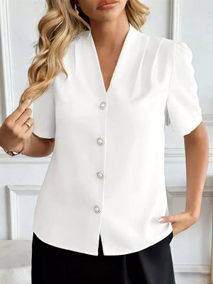 White V-neck short sleeve shirt with pearl button details and puff sleeves.