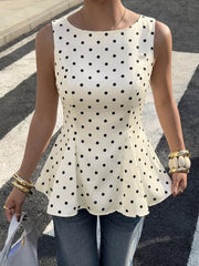 Chic white sleeveless peplum blouse with black polka dots and a boat neckline.