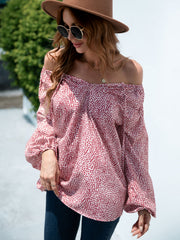 Off-the-shoulder blouson top in deep red with a spotted print and balloon sleeves.