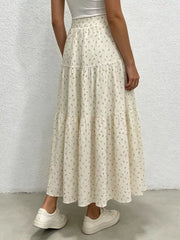 Beige floral tiered maxi skirt with ruched waist detail.