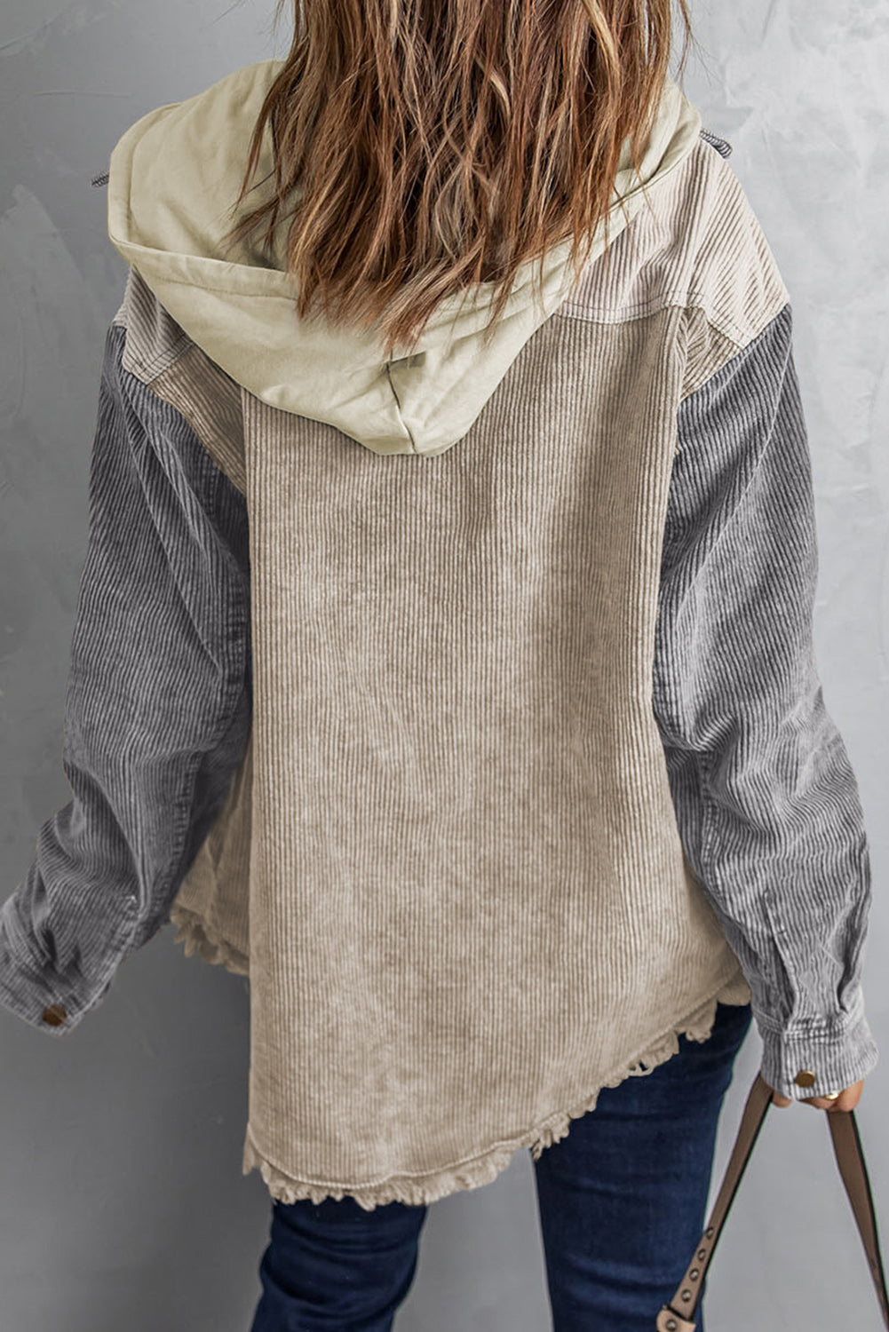 Colorblock corduroy hooded utility jacket in tan and gray with frayed hem.