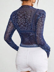 Dark blue mesh mock neck top with bandana print and long sleeves.