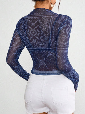 Dark blue mesh mock neck top with bandana print and long sleeves.