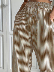 Wide-leg trousers in tan with vertical stripes and a drawstring waist.