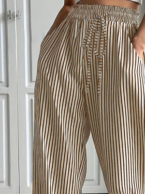 Wide-leg trousers in tan with vertical stripes and a drawstring waist.