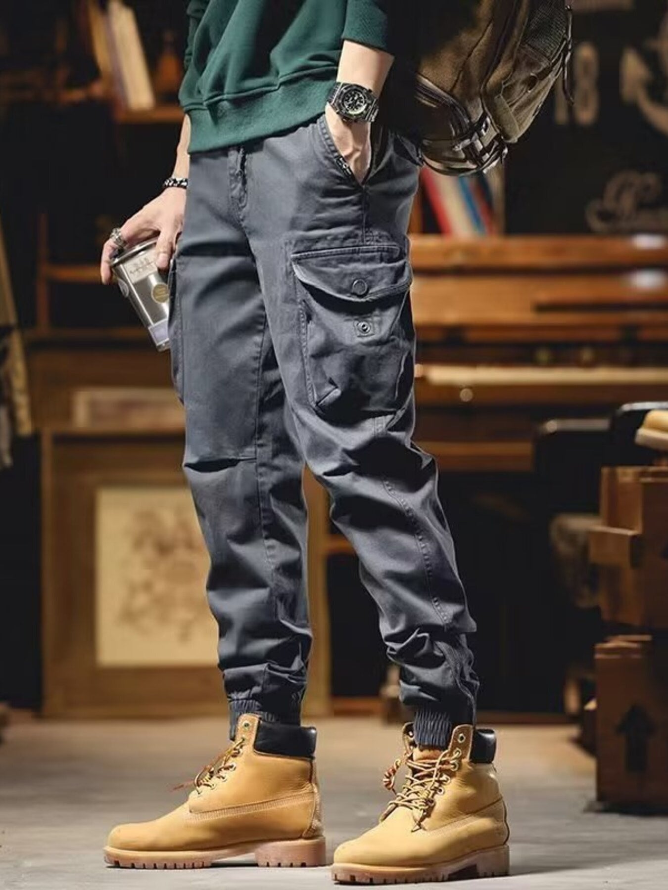 Men's grey cargo joggers with drawstring and multiple pockets.