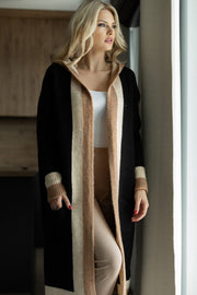 Color-blocked hooded knit maxi cardigan in black with tan and cream stripes, featuring ribbed cuffs.