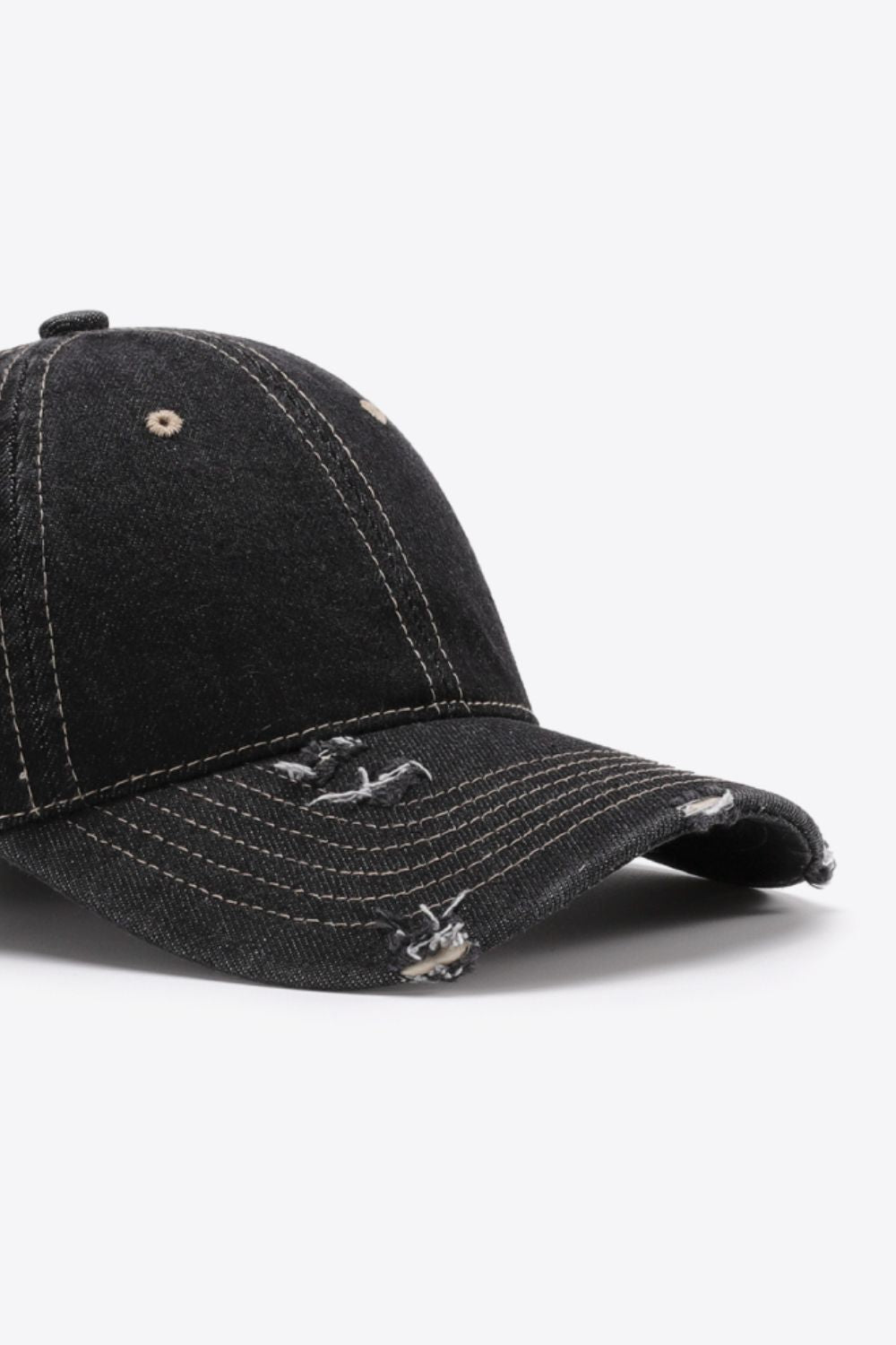 Black distressed baseball cap with contrast stitching and frayed details.