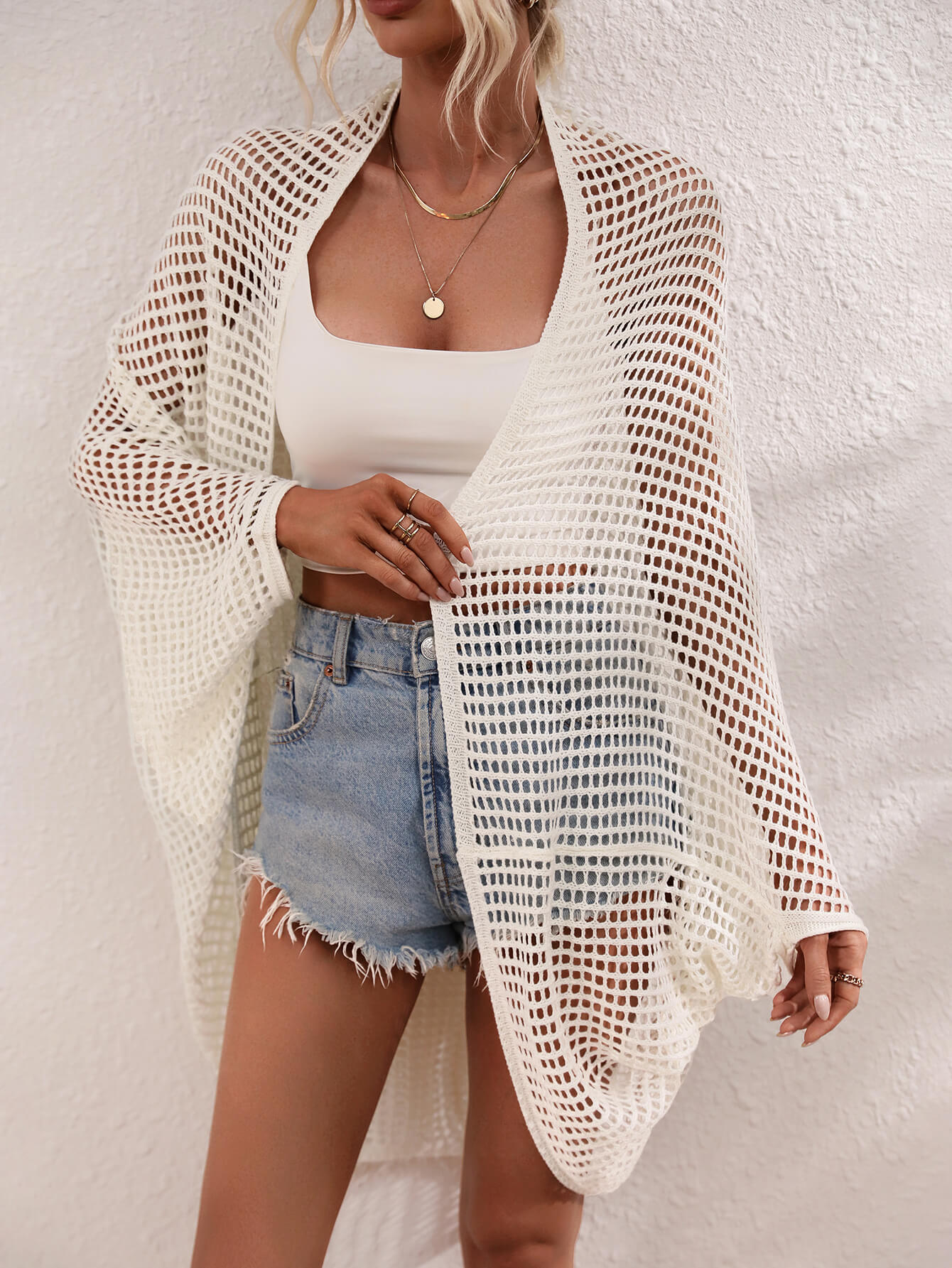White open-weave kimono duster with batwing sleeves and breathable acrylic fabric.
