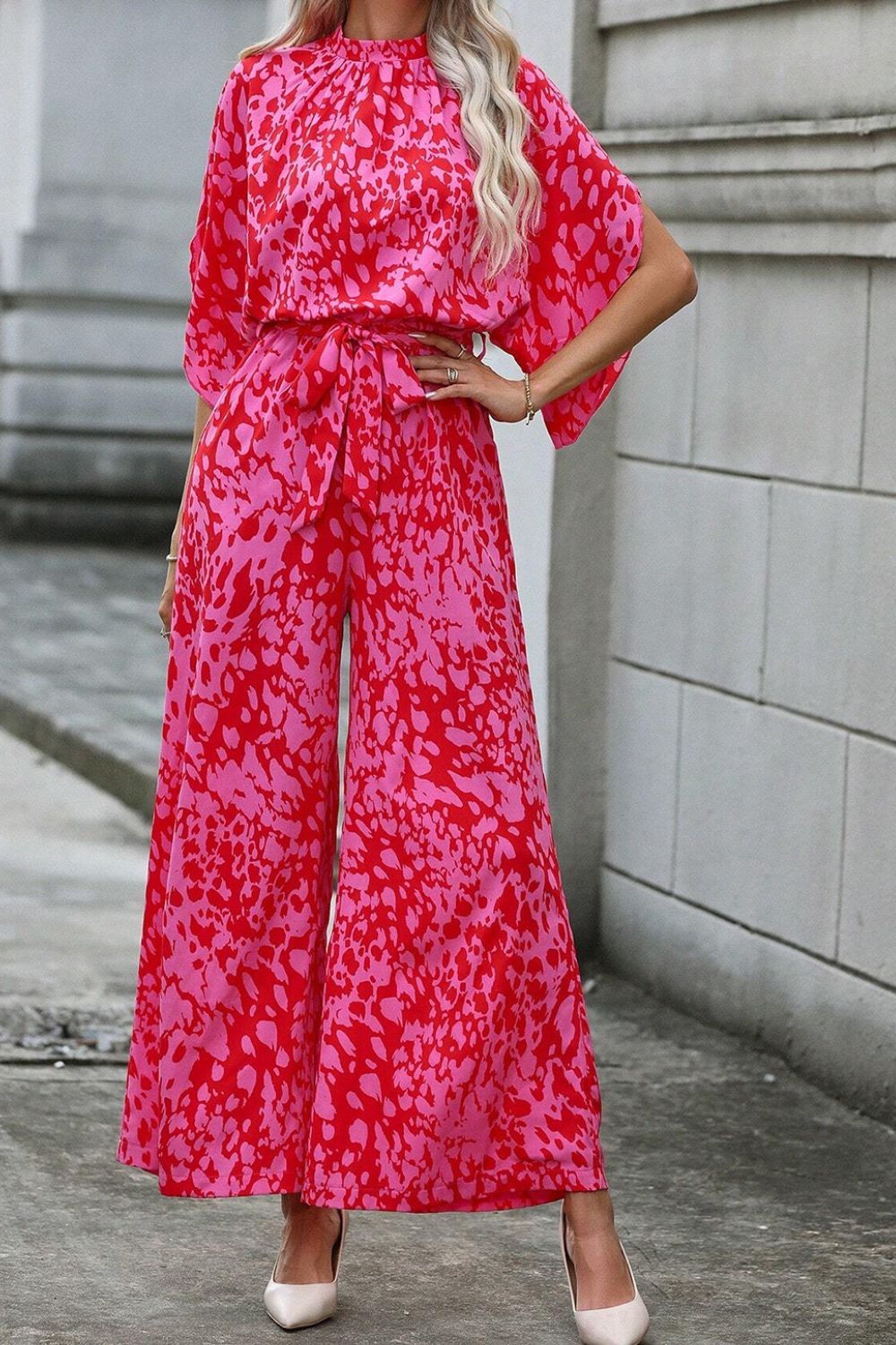 Crimson Splatter Tie-Waist Palazzo Jumpsuit in Hot Pink with wide legs and short sleeves.