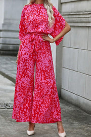 Crimson Splatter Tie-Waist Palazzo Jumpsuit in Hot Pink with wide legs and short sleeves.