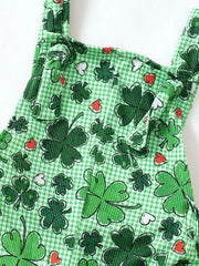 Green plaid overalls with shamrock and heart print, featuring knotted shoulder straps.