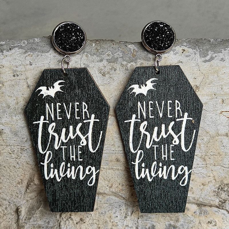 Gothic coffin earrings with white text "Never trust the living" and bat graphic.