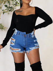 Distressed denim shorts in light blue with bold cutouts and frayed hem.