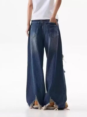 Men's distressed wide-leg jeans in dark wash denim with raw hem and ripped details.
