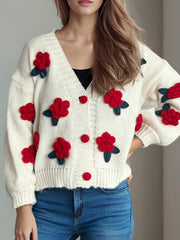 Cream knit cardigan with red rose appliqués and button front.