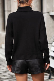 Black knit turtleneck sweater with textured pattern and ribbed cuffs and hem.