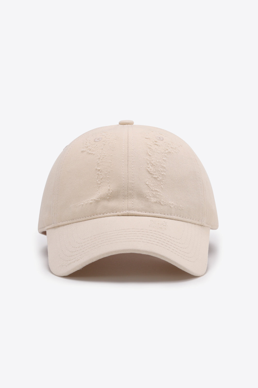Cream baseball cap with distressed details and curved brim
