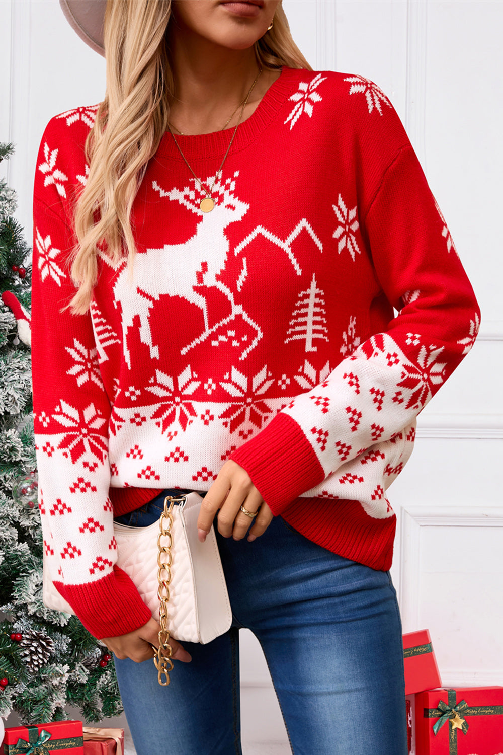 Red acrylic knit sweater with white reindeer, snowflake, and tree Fair Isle pattern.