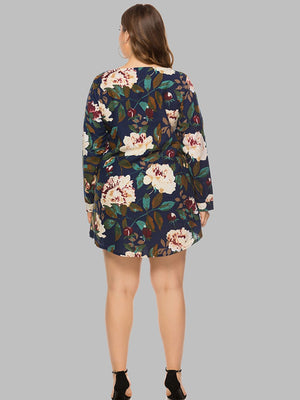 Navy botanical print trapeze mini dress with long sleeves.