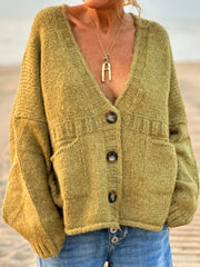 Textured bouclé oversized button-down cardigan in lime with V-neck, pockets, and button closure.