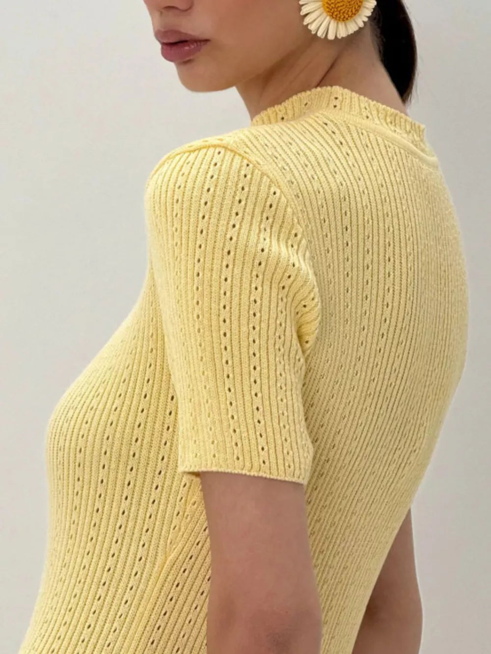 Pastel yellow knit swim dress with short sleeves and eyelet details.