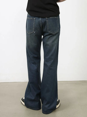 Flared dark wash denim jeans with subtle fading and bootcut leg