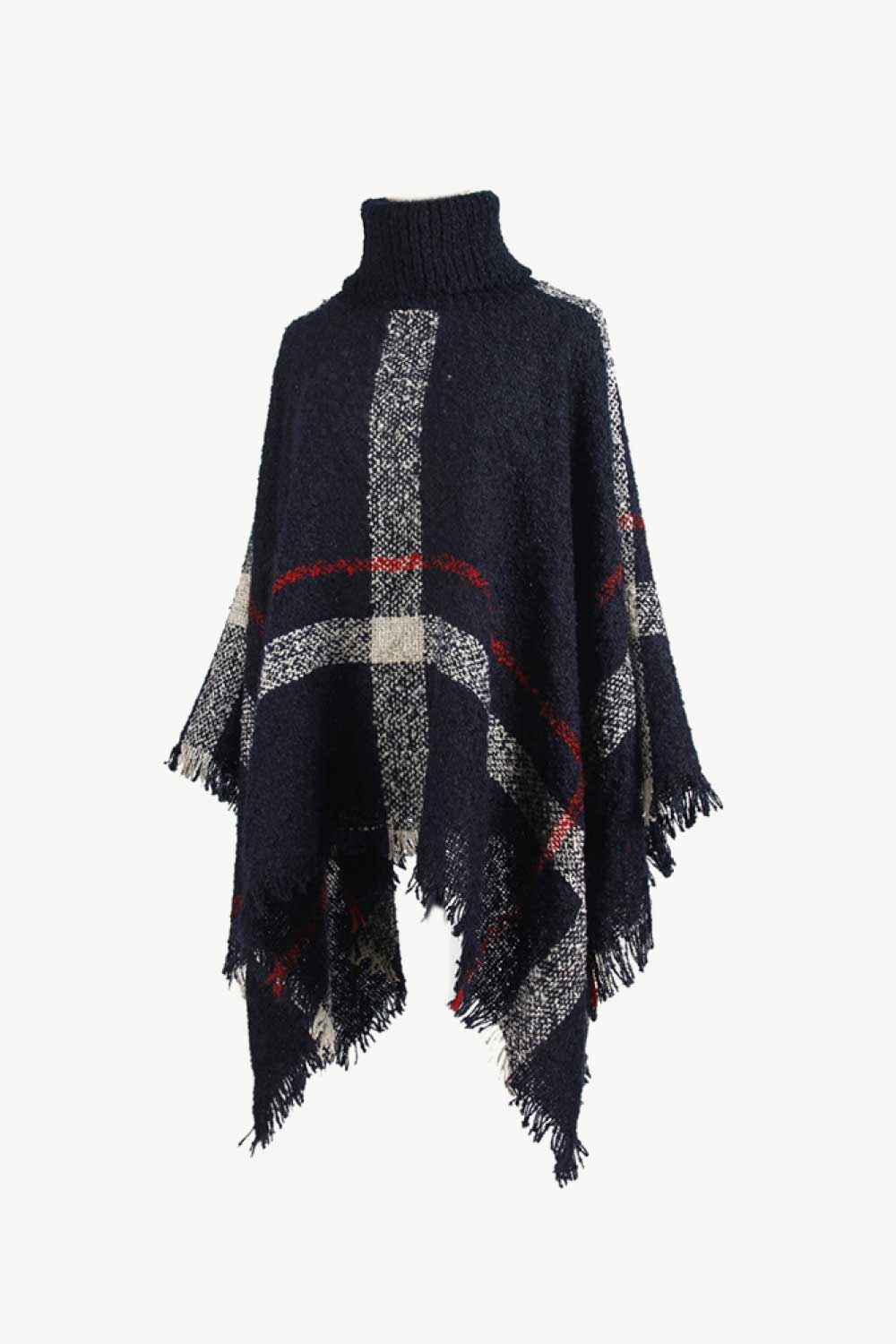 Navy plaid turtleneck cape with fringe detail and textured acrylic knit.